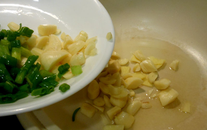 Adding the Sliced Ginger, Garlic, and Green Onion to Clay Pot and Oil Recipe