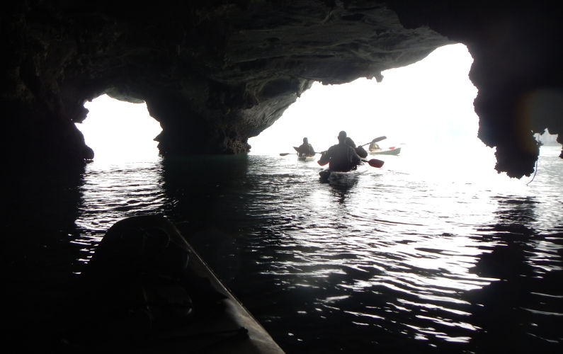Exiting a Sea Cave by Kayak with Friends from the Indochina Junk