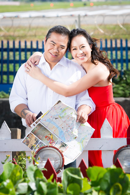 Nadia in a Red Dress Holding JM with a Map at Taipei Songshan Airport By Ching Hua