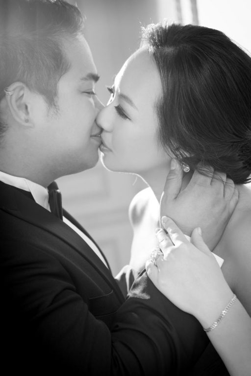 Nadia in a Dark Blue Wedding Dress Being Kissed By JM in a Black Tuxedo by Ching Hua Bridal Art