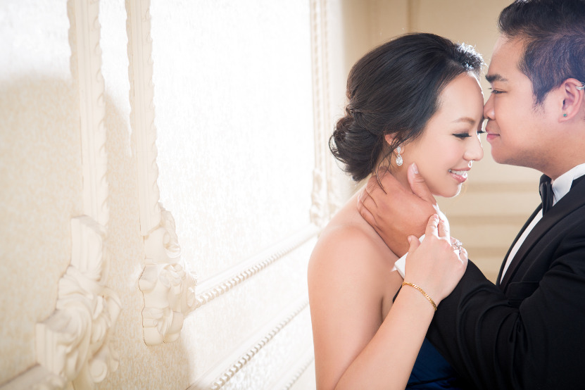 Nadia in a Dark Blue Wedding Dress Being Kissed on the Forehead by JM in a Black Tuxedo by Ching Hua Bridal Art