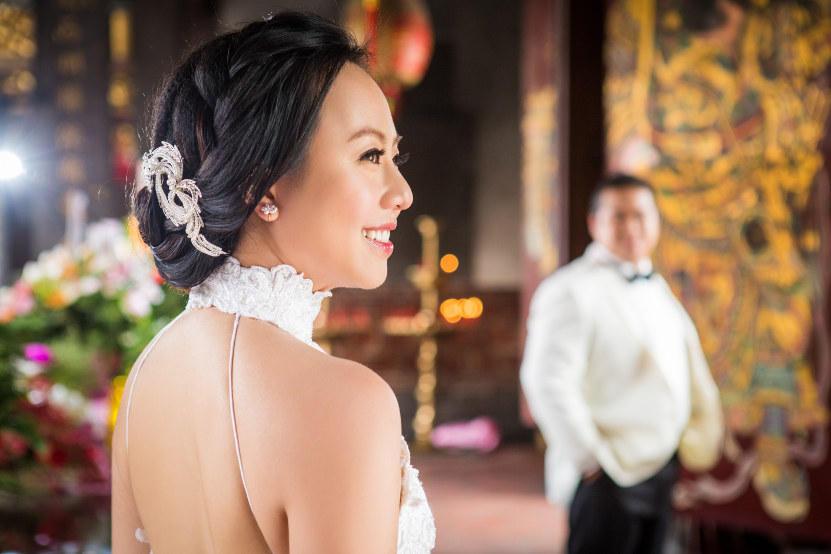 Nadia in a White Dress Being Looked at by Out of Focus JM in a Black and White Tuxedo at Lungshan Temple By Ching Hua Bridal Art